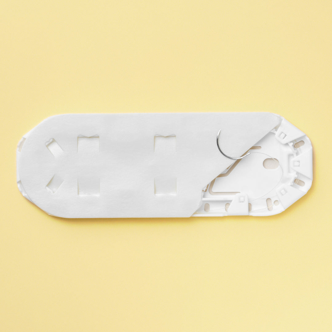 Box of 5-0 Surgical Gut Suture - Plain, model 1632G, featuring yellowish tan sutures paired with a 16mm PS-4 reverse cutting needle. The packaging emphasizes the suture's absorbable qualities and its specialized design for precise wound closure, highlighting its suitability for delicate surgical applications.