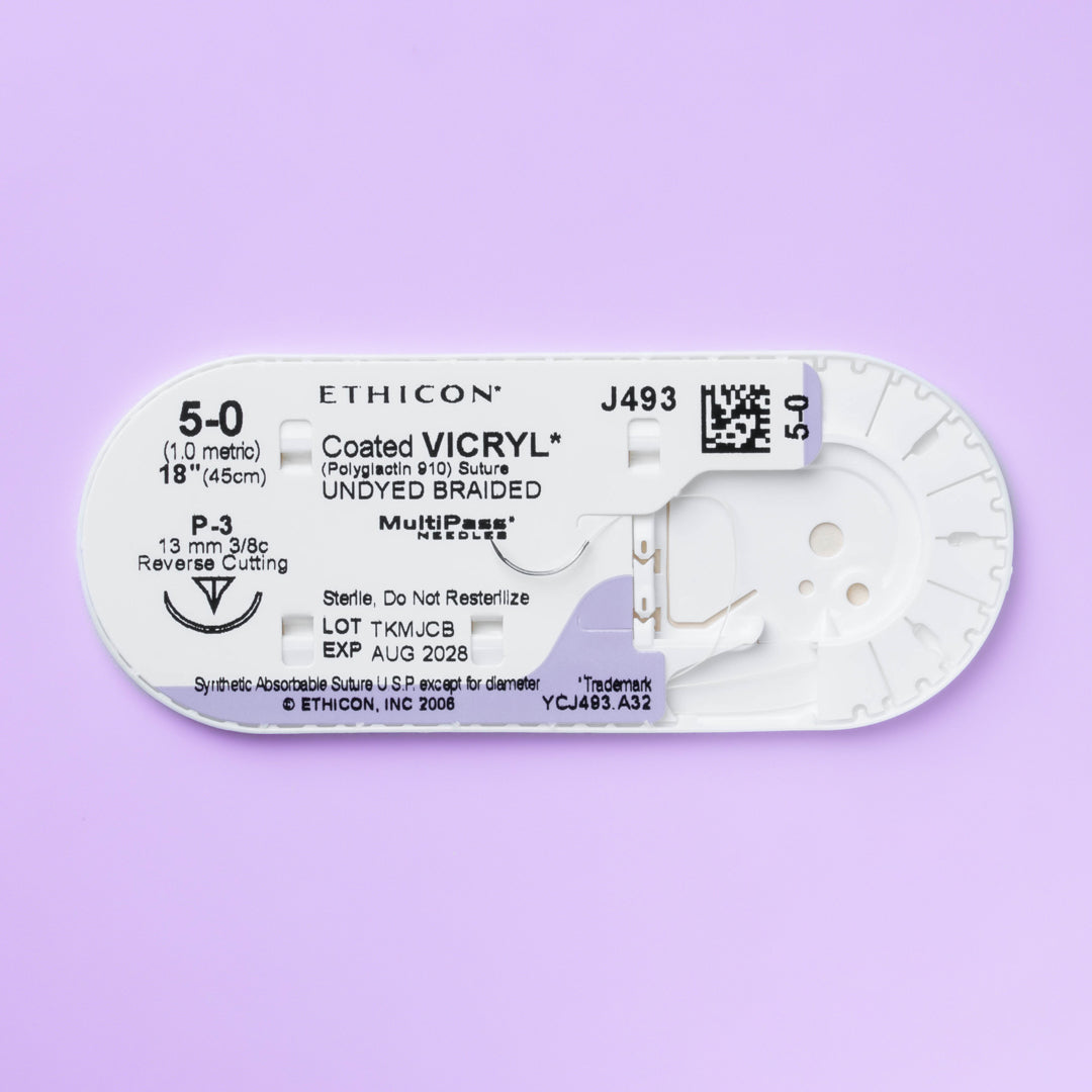 Close-up of COATED VICRYL® 5-0 Undyed Sutures, model J493G, featuring sutures with a 13mm P-3 prime reverse cutting needle. The packaging highlights the suture's advanced design for delicate surgical applications, emphasizing its absorbable nature and commitment to promoting effective and comfortable patient recovery.