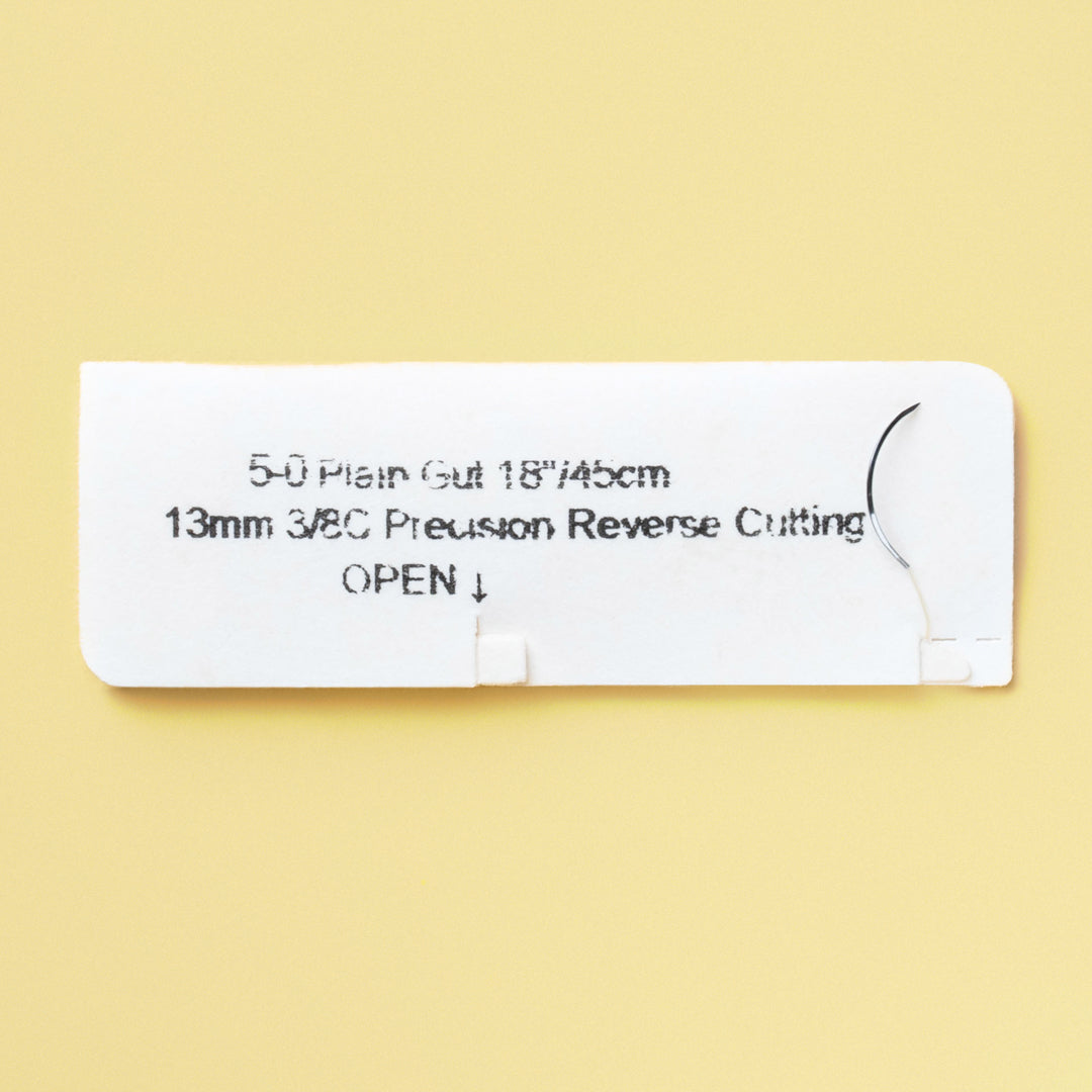 Box of 5-0 Plain Gut sutures with a C-3 precision reverse cutting needle, model 596B, detailing the 1-week wound support, marked with a QR code for instant identification. The packaging emphasizes the suture's sterile and absorbable qualities for effective surgical applications.
