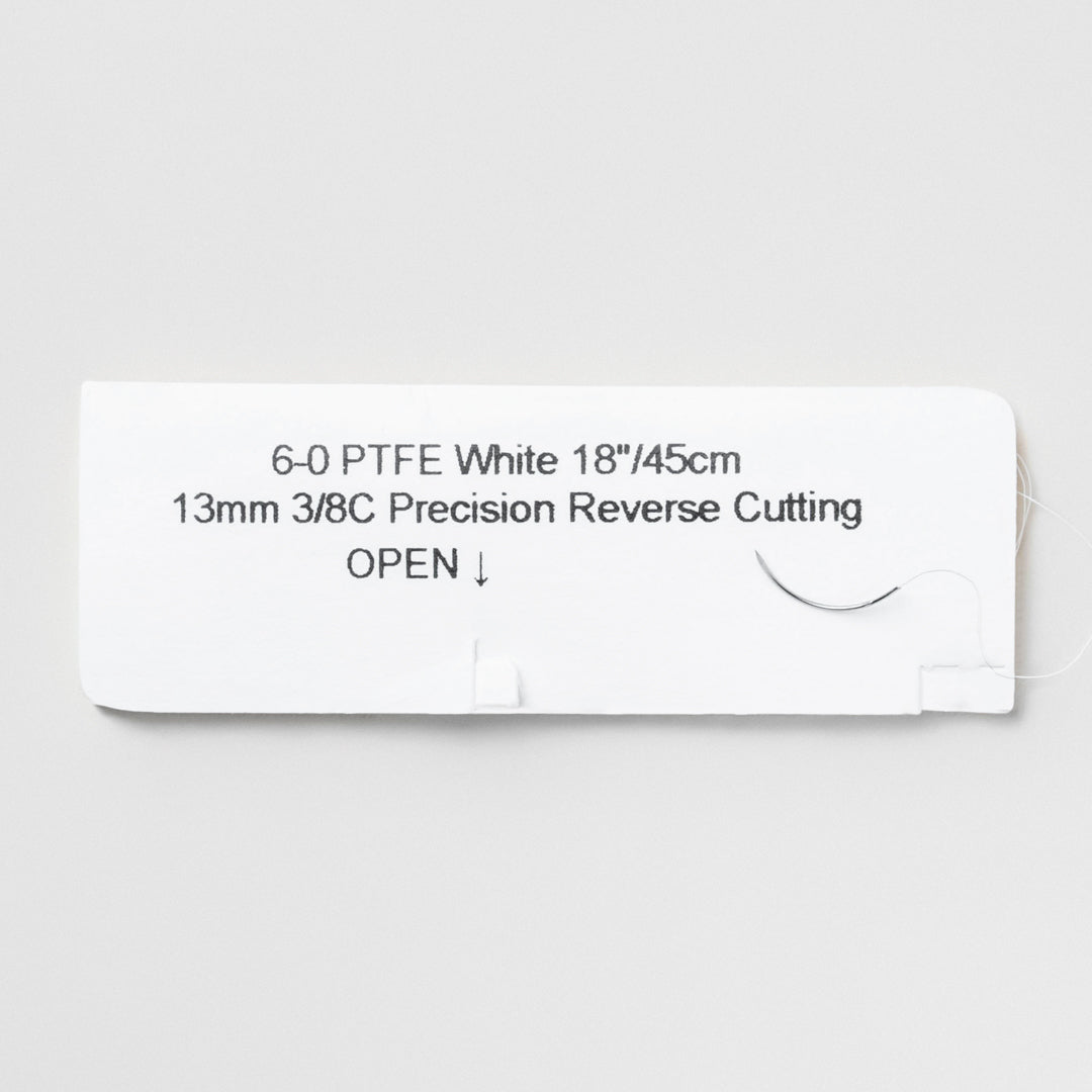 A box and individual pack of 6-0 PTFE white sutures featuring an 18-inch C-3 precision reverse cutting needle, labeled with the product code 822B, denoting the suture's non-absorbable quality. The packaging includes a QR code for instant access to comprehensive product details, ensuring a trusted choice for prolonged tissue support in dental and periodontal surgeries.