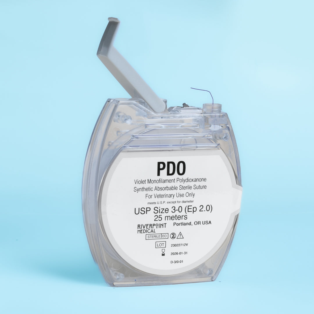 An image of a clear micro cassette containing a 25-meter roll of 3-0 PDO violet monofilament suture, labeled for veterinary use. The suture's specifications, including its size, length, and color, are clearly displayed, along with its absorbable nature and suitability for a range of surgical procedures. This product exemplifies high-quality surgical materials designed for effective and safe veterinary applications.