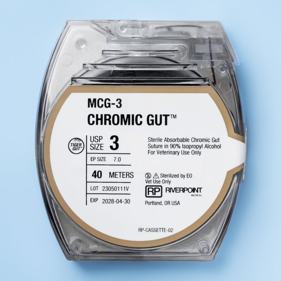 Image of RIVERPOINT MCG-3 Chromic Gut suture cassette, showcasing a 40-meter violet suture coil, size 3 (Ep 7.0), for veterinary surgical use. The label indicates gamma irradiation sterilization, a two-week wound support duration, and ethylene oxide (EO) sterilization method. The product, marked for its high-quality chromic gut material, promises reliable performance and ease of use in a variety of surgical applications.